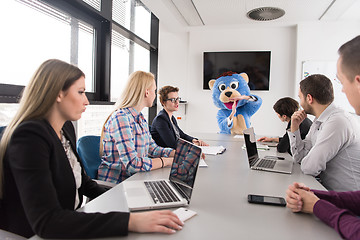 Image showing boss dresed as bear having fun with business people in trendy of