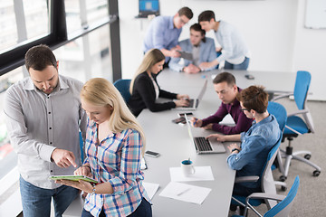 Image showing Two Business People Working With Tablet in office