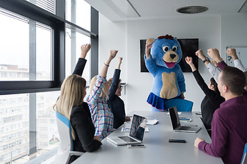 Image showing boss dresed as bear having fun with business people in trendy of