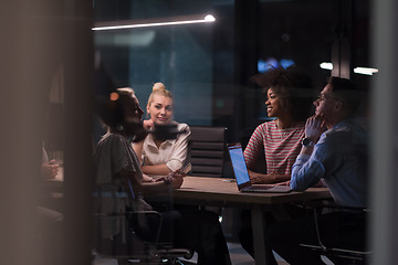 Image showing Multiethnic startup business team in night office