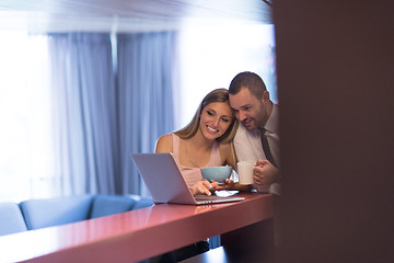 Image showing A young couple is preparing for a job and using a laptop