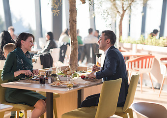 Image showing Young parents enjoying lunch time with their children