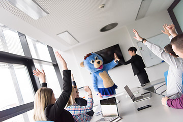 Image showing boss dresed as bear having fun with business people in trendy of