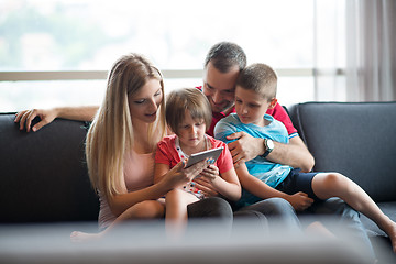 Image showing happy young couple spending time with kids