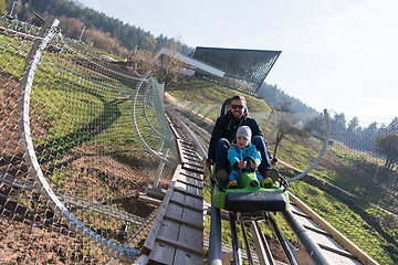 Image showing father and son enjoys driving on alpine coaster