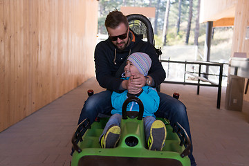 Image showing father and son enjoys driving on alpine coaster