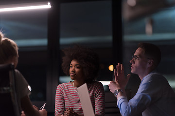 Image showing Multiethnic startup business team in night office