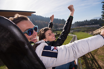 Image showing couple enjoys driving on alpine coaster