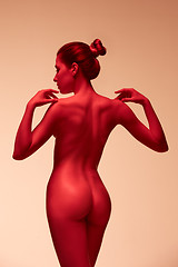 Image showing fashion art photo of elegant nude model in the light colored spotlights