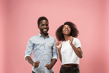 Image showing Winning success woman happy ecstatic celebrating being a winner. Dynamic energetic image of female afro model