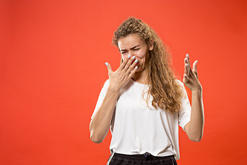 Image showing Let me think. Doubtful pensive woman with thoughtful expression making choice against pink background