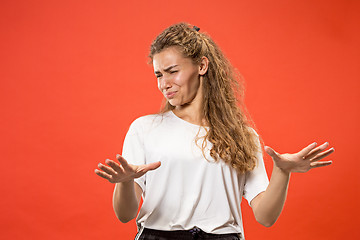 Image showing Let me think. Doubtful pensive woman with thoughtful expression making choice against pink background