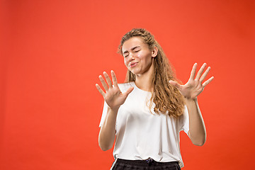 Image showing Let me think. Doubtful pensive woman with thoughtful expression making choice against pink background