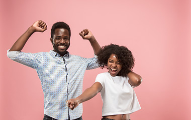 Image showing Winning success woman happy ecstatic celebrating being a winner. Dynamic energetic image of female afro model