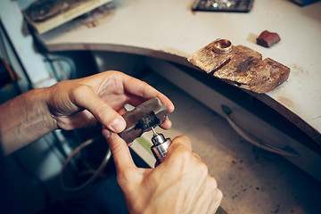 Image showing Different goldsmiths tools on the jewelry workplace. Jeweler at work in jewelry.