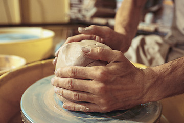 Image showing Creating a jar or vase of white clay close-up. Master crock.