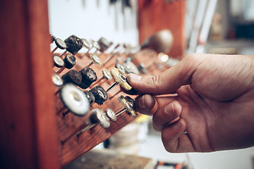 Image showing Different goldsmiths tools on the jewelry workplace. Jeweler at work in jewelry.