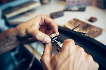 Image showing Different goldsmiths tools on the jewelry workplace. Jeweler at work in jewelry.