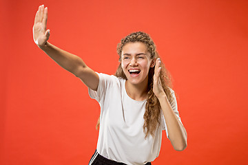 Image showing Isolated on pink young casual woman shouting at studio