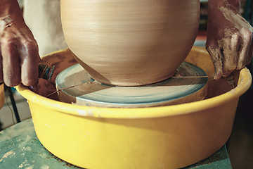 Image showing Creating a jar or vase of white clay close-up. Master crock.