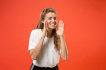 Image showing Isolated on pink young casual woman shouting at studio