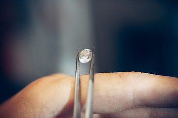 Image showing Different goldsmiths tools on the jewelry workplace. Jeweler at work in jewelry.