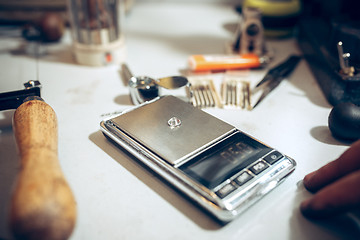 Image showing Different goldsmiths tools on the jewelry workplace. work in jewelry.