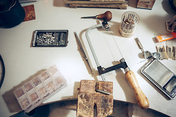 Image showing Different goldsmiths tools on the jewelry workplace. work in jewelry.