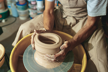 Image showing Creating a jar or vase of white clay close-up. Master crock.