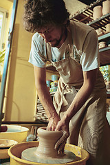 Image showing Creating a jar or vase of white clay close-up. Master crock.