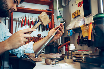 Image showing Different goldsmiths tools on the jewelry workplace. Jeweler at work in jewelry.