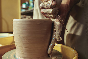 Image showing Creating a jar or vase of white clay close-up. Master crock.