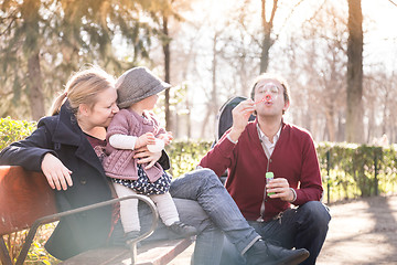 Image showing Young family with cheerful child in the park.