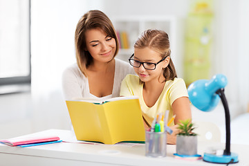 Image showing mother and daughter doing homework together