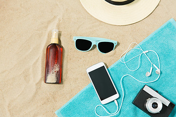 Image showing smartphone, camera, towel, hat and shades on beach