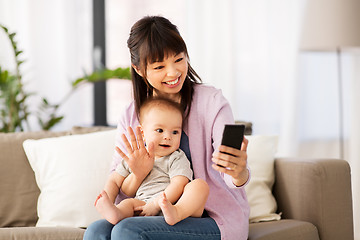 Image showing asian mother with baby son taking selfie at home