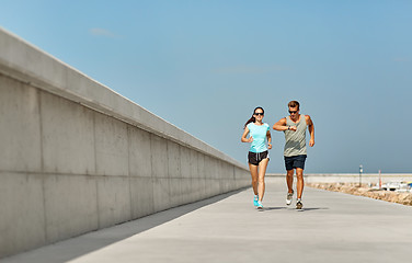 Image showing couple in sports clothes running outdoors