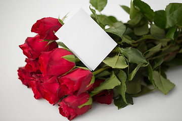 Image showing close up of red roses and letter or note