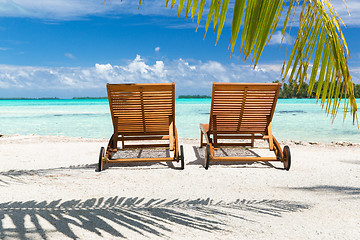 Image showing tropical beach with palm tree and sunbeds