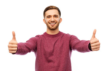 Image showing happy young man showing thumbs up