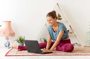 Image showing woman with laptop computer at yoga studio