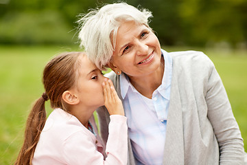 Image showing granddaughter sharing secrets with grandmother