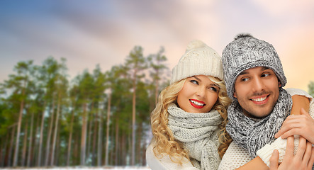 Image showing couple hugging over winter forest background