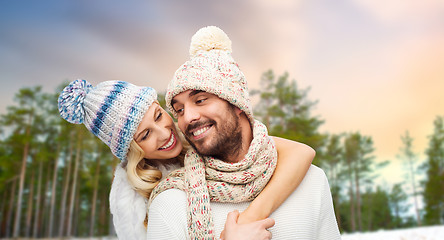 Image showing couple hugging over winter forest background