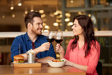 Image showing couple eating and drinking red wine at restaurant