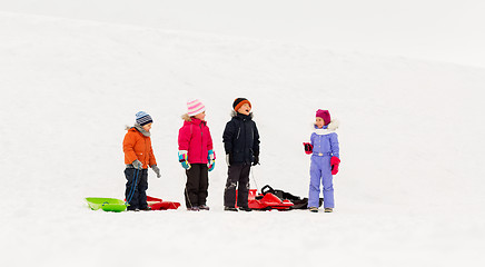 Image showing happy little kids with sleds in winter