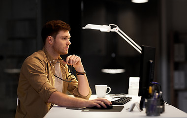 Image showing man with computer working late at night office