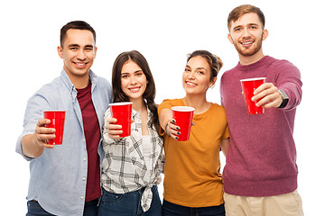 Image showing group of smiling friends with drinks in party cups