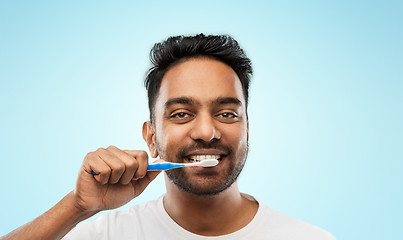 Image showing indian man with toothbrush cleaning teeth