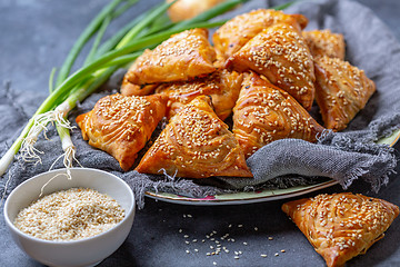 Image showing Homemade samosas sprinkled with sesame seeds.